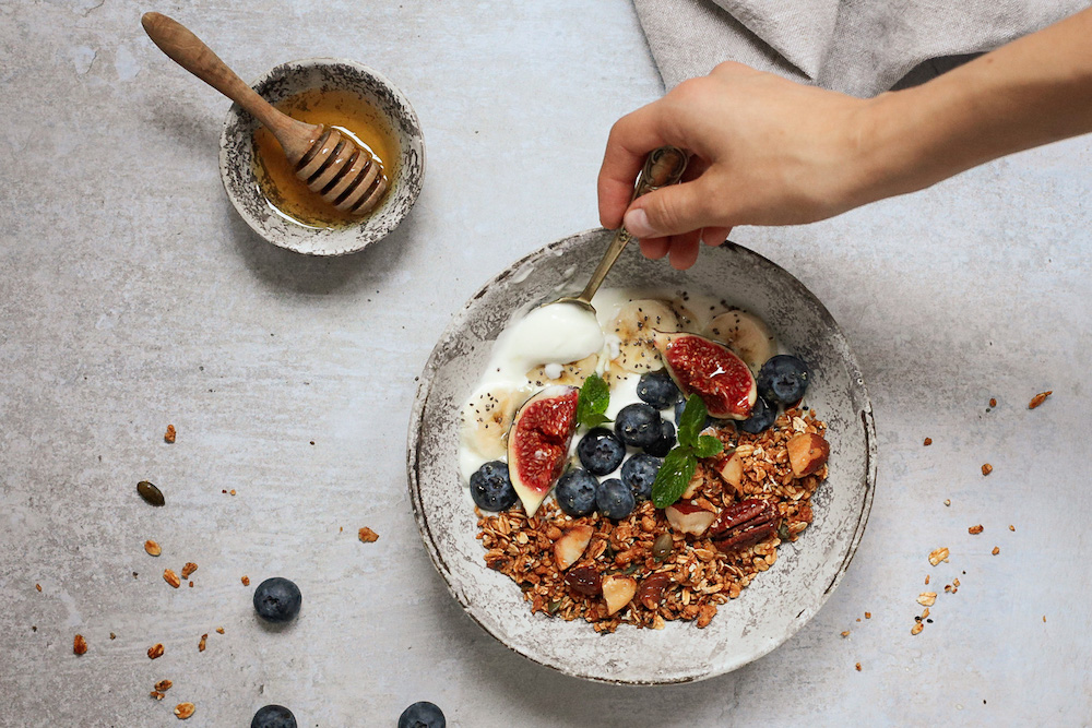 A bowl of granola and yogurt. 